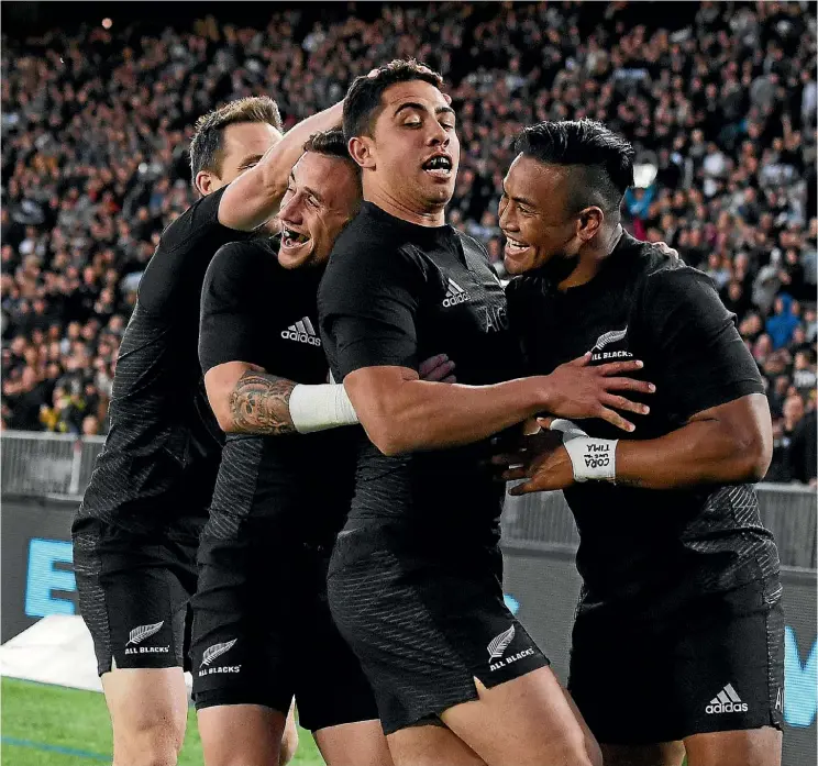  ??  ?? The All Blacks flock to celebrate with Anton Lienert-Brown after the young centre’s try in the first half last night.