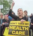  ?? NICHOLAS KAMM, AFP/GETTY IMAGES ?? Protesters shout at lawmakers walking out of the U.S. Capitol after the health care bill passed Thursday.