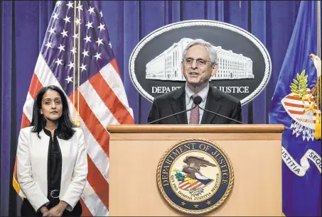  ?? Drew Angerer Tribune News Service ?? Associate Attorney General Vanita Gupta, left, looks on as U.S. Attorney General Merrick Garland speaks during a news conference at the U.S. Department of Justice in 2022 in Washington, D.C.