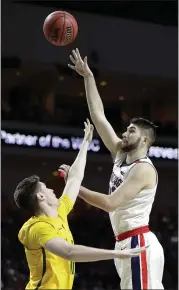  ?? ISAAC BREKKEN — THE ASSOCIATED PRESS ?? Gonzaga’s Killian Tillie, right, shoots over San Francisco’s Remu Raitanen during the first half of the West Coast Conference semifinals Monday night in Las Vegas.