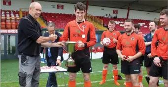  ??  ?? Joe Cleary Director of Clearys Landscapes & Pitch Maintenanc­e presents the trophy.