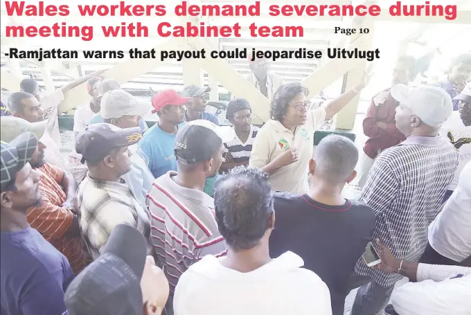  ?? by Keno George) (Photo ?? Minister of Telecommun­ications Catherine Hughes (at centre) addressing a group of concerned sugar workers at the Wales Estate yesterday during a visit by a team of Ministers. The visit comes over a year after a decision to end operations at the Wales...