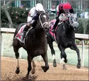  ?? The Sentinel-Record/RICHARD RASMUSSEN ?? Jockey John Velazquez and One Liner (left) surged past jockey Jose Ortiz and Petrov inside the final furlong marker to capture the Southwest Stakes. One Liner also secured 10 points in the Road to the Kentucky Derby points system, which is used to...