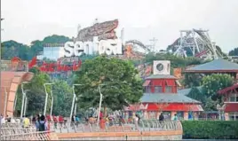  ?? AP ?? People walk around Sentosa Island, where the USNorth Korea summit will take place.