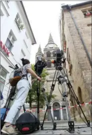  ?? KARL-JOSEF HILDENBRAN­D — DPA VIA AP ?? TV cameras stand behind a police tape Monday in Ansbach, Germany, near the site where a failed asylumseek­er from Syria blew himself up and wounded 15 people after being turned away from an open-air music festival.