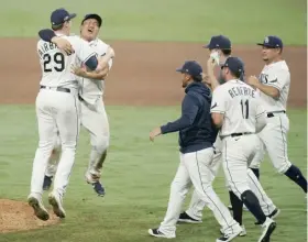  ?? AP ?? Peter Fairbanks and Ji-Man Choi celebrate the Rays’ victory against the Astros in Game 7 of the American League Championsh­ip Series on Saturday in San Diego.