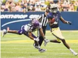  ?? PAUL W. GILLESPIE/AP ?? Mychal Cooper and the Navy offense left East Carolina defenders grasping at air last season.