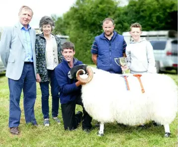  ??  ?? Waterford’s Gary Norris with his Scottish Blackface supreme show champion shearling ram at Kilgarvan Agricultur­al Show, Kerry with the Minister of Agricultur­e Michael Creed, the judge Patrick Randles, and Margaret and Andrew Norris