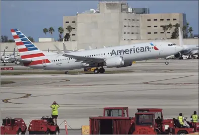  ?? Joe Raedle / Getty Images ?? American Airlines flight 718, a Boeing 737 Max, takes off from Miami Internatio­nal Airport to New York on Tuesday in Miami, Fla. The Boeing 737 Max flew its first commercial flight since the aircraft was allowed to return to service nearly two years after being grounded worldwide following a pair of separate crashes.