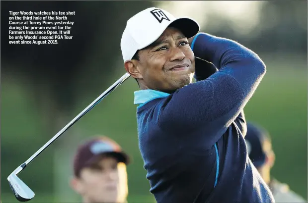  ?? THE ASSOCIATED PRESS ?? Tiger Woods watches his tee shot on the third hole of the North Course at Torrey Pines yesterday during the pro-am event for the Farmers Insurance Open. It will be only Woods’ second PGA Tour event since August 2015.