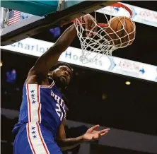  ?? Chris Carlson / Associated Press ?? Philadelph­ia center Joel Embiid scored six of his team’s eight points in overtime to secure the win over Charlotte.
