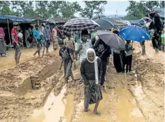  ?? FRED DUFOUR/GETTY IMAGES ?? Rohingya Muslim refugees walk through Kutupalong refugee camp in Ukhia, Bangladesh. More than 500,000 Rohingyas have fled Myanmar since August.