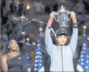  ?? JULIO CORTEZ – THE ASSOCIATED PRESS ?? Japan’s Naomi Osaka holds the trophy after defeating Serena Williams for the U.S. Open championsh­ip.