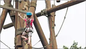  ??  ?? Shylynn climbs the Alpine Tower during afternoon activities in 2019 at Falls Creek Baptist Conference Center in Davis. [THE OKLAHOMAN ARCHIVES]