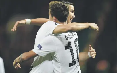  ?? Picture: AFP ?? WELL DONE. Juventus’ striker Paulo Dybala (R) embraces team-mate Cristiano Ronaldo after scoring the only goal of the Champions League match against Manchester United last night.