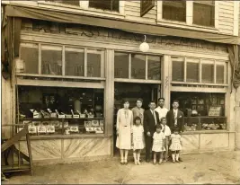  ?? COURTESY OF ANGEL CITY PRESS ?? In an image from “Terminal Island: Lost Communitie­s on America's Edge, Orie Mio, second from left, stands in front of the first Mio Café, located at 777Tuna Street circa 1928.
