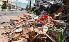  ?? Will Waldron / Times Union ?? Debris from a neighborho­od fireworks display was swept into a pile on Monday along Hulett Street in Schenectad­y.