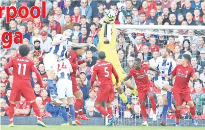  ??  ?? PENJAGA gol Liverpool Alisson beraksi cemerlang menyelamat­kan salah satu percubaan ke pintu gawangnya dalam perlawanan menentang Brighton di Anfield.-Gambar AFP