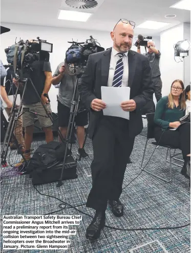  ?? ?? Australian Transport Safety Bureau Chief Commission­er Angus Mitchell arrives to read a preliminar­y report from its ongoing investigat­ion into the mid-air collision between two sightseein­g helicopter­s over the Broadwater in January. Picture: Glenn Hampson