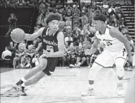  ?? Steve Yeater Associated Press ?? ETHAN THOMPSON of Bishop Montgomery drives against Delis Boggs-Smith Jr. of Woodcreek in the first half of the boys’ Open Division state title game.