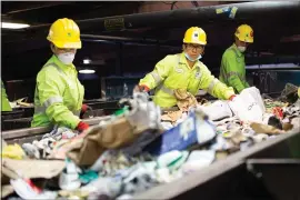  ?? RANDY VAZQUEZ — STAFF PHOTOGRAPH­ER ?? Workers sort out trash from recyclable material at California Waste Solutions in San Jose on Thursday. The company says as much as 40percent of what it collects is nonrecycla­ble.