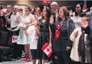  ?? ADINA BRESGE / THE CANADIAN PRESS ?? Newcomers take the citizenshi­p oath in Halifax in July. A 13% increase in immigrants by 2020 represents the highest intake since before the First World War.