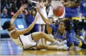  ?? JESSICA HILL — THE ASSOCIATED PRESS ?? Connecticu­t’s Gabby Williams, left, and UCLA’s Jordin Canada scramble on the floor for a loose ball during the first half of a regional semifinal game in the NCAA women’s college basketball tournament, Saturday in Bridgeport, Conn.