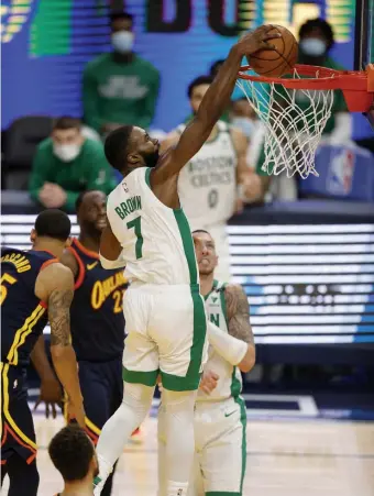  ?? GeTTy IMaGes PhOTOs ?? EASY BUCKET: Celtics guard Jaylen Brown struggled early on Tuesday night against the Warriors, but came on strong late with a dunk and key defensive plays. Top right, Jeff Teague battles with Warriors grinder Draymond Green for the ball. For a story on Wednesday night’s matchup with the Sacramento Kings, which ran past press time, visit www.bostonhera­ld.com.