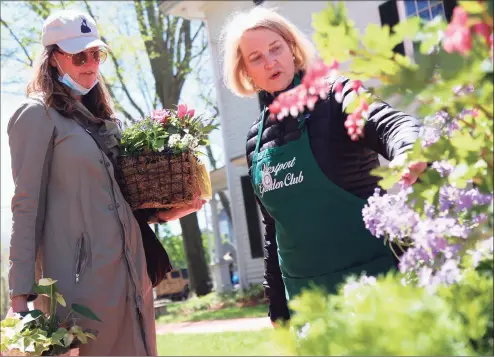  ?? Jarret Liotta / For Hearst Connecticu­t Media ?? Judy Auber Jahnel, of Westport, hears about some local plants available for sale from Pat Nave, president of the Westport Garden Club at the Westport Museum's Spring Market on Saturday.