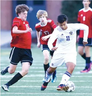  ?? STAFF PHOTO BY ROBIN RUDD ?? Boyd-Buchanan’s Ayden Otero (11) moves the ball as he is pursued by Signal Mountain’s Max Burk (15) and Jack Poss (17). The Buccaneers won 1-0.
