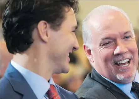  ?? DARRYL DYCK/THE CANADIAN PRESS ?? B.C. Premier John Horgan, right, and Prime Minister Justin Trudeau celebrate the announceme­nt Tuesday in Vancouver that Shell and its joint-venture partners would fund LNG Canada, the biggest private-sector investment in Canada’s history.