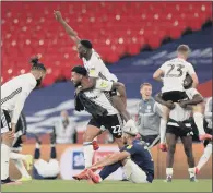  ??  ?? GOING UP: Fulham celebrate winning as the Brentford players appear dejected after the Sky Bet Championsh­ip Play- off Final at Wembley.
