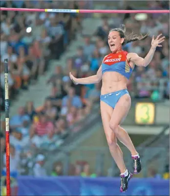  ?? LUCY NICHOLSON / REUTERS ?? Russia’s Yelena Isinbayeva reacts after clearing the bar to win the pole vault final at the IAAF World Athletics Championsh­ips at Luzhniki Stadium in Moscow on Tuesday.