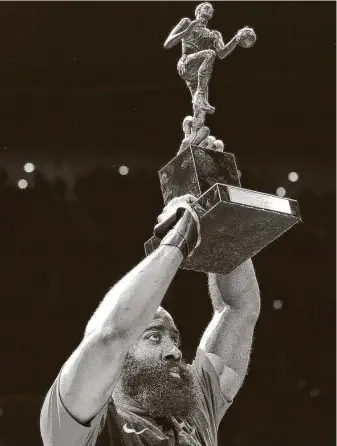  ?? Elizabeth Conley / Staff photograph­er ?? Rockets guard James Harden shows off his 2017-2018 NBA MVP trophy before the season home opener against the Pelicans on Oct. 17, 2018, at the Toyota Center.