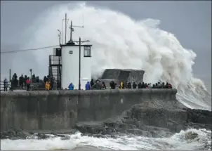  ?? BEN BIRCHALL / AP ?? Waves pound a harbor wall at Porthcawl, Wales, as Storm Dennis hits on Saturday.