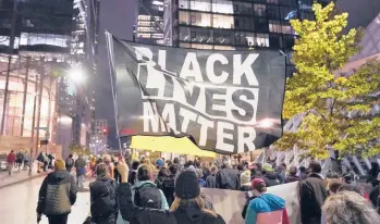  ?? TED S. WARREN/AP ?? Protesters representi­ng Black Lives Matter and Protect the Results march last year in Seattle. A financial snapshot shared with The Associated Press shows the BLM Global Network Foundation took in just over $90 million in 2020.