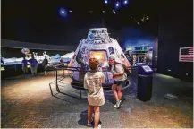  ??  ?? Sara Budd takes a photo of Emmi Irwin in front of an Apollo 17 Command Module.