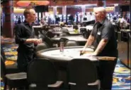  ?? WAYNE PARRY — THE ASSOCIATED PRESS ?? Workers install a card table inside the Ocean Resort Casino as the former Revel property prepares to reopen under a new owner and a new brand on June 28.