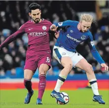  ?? RUI VIEIRA THE ASSOCIATED PRESS ?? Everton's Tom Davies, right, and Manchester City's Ilkay Gundogan battle Saturday in Premier League soccer action. City is in Liverpool for a Champions League contest Wednesday.