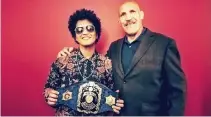  ??  ?? Bruno Mars, left, meeting retired profession­al wrestler Bruno Sammartino, right, as Mars holds Sammartino’s world champion belt, coinciding with a concert as part of Mars’ 24K Magic World Tour in Pittsburgh. (AP)