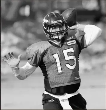  ?? AP Photo ?? The Broncos’ Tim Tebow works on his passing game during Wednesday’s practice. NFL defenses now try to force him to pass rather than allow him to scramble.