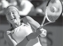  ?? Caroline Blumberg European Pressphoto Agency ?? JELENA OSTAPENKO strikes the ball during her win over Timea Bacsinszky. Ostapenko became the first unseeded French Open finalist since 1983.