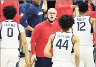  ?? David Butler II / Associated Press ?? UConn coach Dan Hurley greets his players during a break against Georgetown in the first half on Saturday.