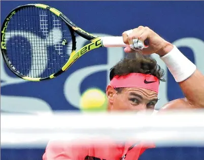 ?? FRANK FRANKLIN II / AP ?? Rafael Nadal of Spain hits a return during his 7-6 (6), 6-2, 6-2 victory against Dusan Lajovic of Serbia, during the first round of the US Open on Tuesday in New York.