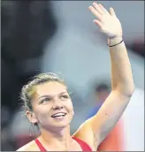  ??  ?? Simona Halep of Romania acknowledg­es the crowd after winning her women's singles match against Maria Sharapova of Russia