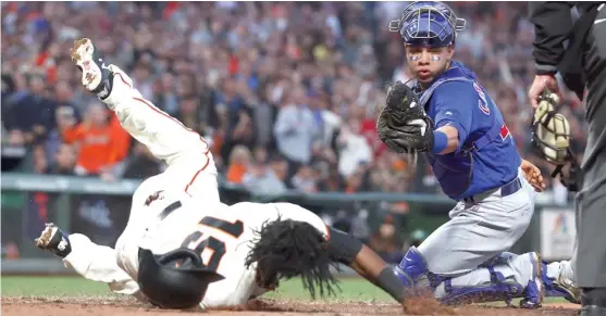  ?? BEN MARGOT/ AP ?? The Giants’Alen Hanson scores a run againstWil­lson Contreras, the NL’s starting catcher for next week’s All- Star Game, in the fifth inning of Monday’s 2- 1 Cubs loss.