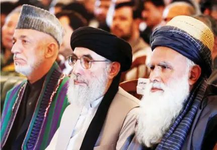  ??  ?? Former Afghan insurgent leader Gulbuddin Hekmatyar, center, former Afghan President Hamid Karzai, left, and former militant leader Abdul Rabb Rasool Sayyaf attend a welcoming ceremony at the presidenti­al palace in Kabul on May 4, 2017. (Reuters/File)