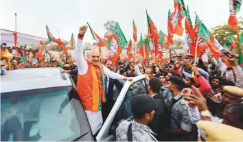  ?? PTI ?? BJP chief Amit Shah during a road show in Udaipur, Rajasthan, last week. The BJP has promised to spend Rs50b in the next five years for the developmen­t of tribal areas and welfare of SCs and STs.