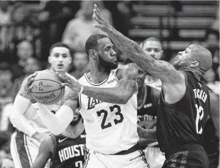  ?? Steve Gonzales / Staff photograph­er ?? Lakers star LeBron James, left, and P.J. Tucker have been going head-to-head “since we were little kids,” says the Rockets forward.