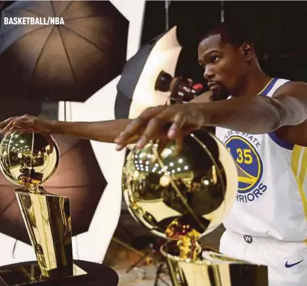  ??  ?? Kevin Durant of the Golden State Warriors with two Larry O’Brien NBA Championsh­ip trophies and two NBA Finals MVP trophies during the Golden State Warriors media day on Wednesday.